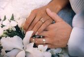wedding rings and hands holding each other following marriage